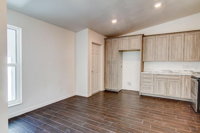 kitchen featuring light brown cabinets, vaulted ceiling, dark wood finished floors, and recessed lighting