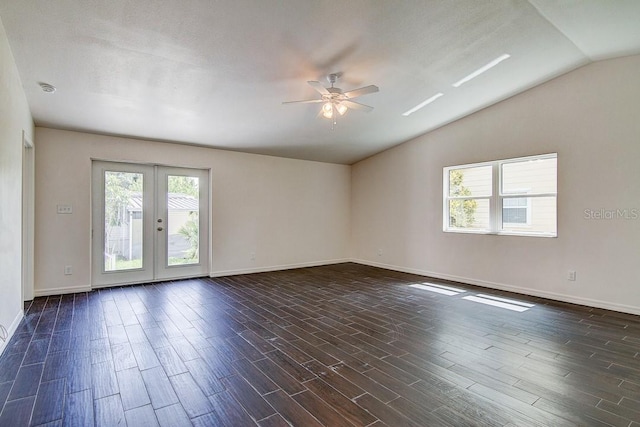 empty room featuring ceiling fan, baseboards, vaulted ceiling, french doors, and dark wood finished floors