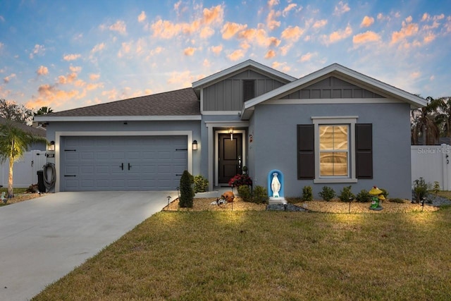 single story home featuring a garage, a front yard, concrete driveway, and board and batten siding