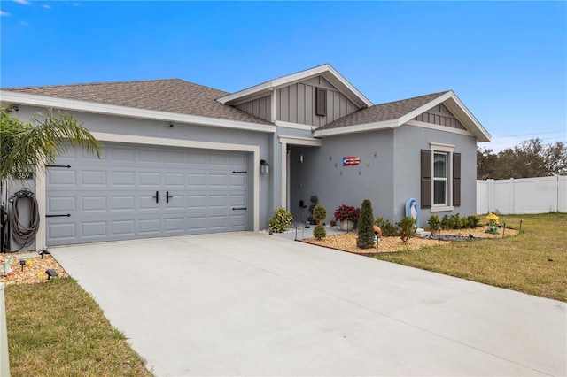 single story home with concrete driveway, roof with shingles, an attached garage, fence, and a front yard