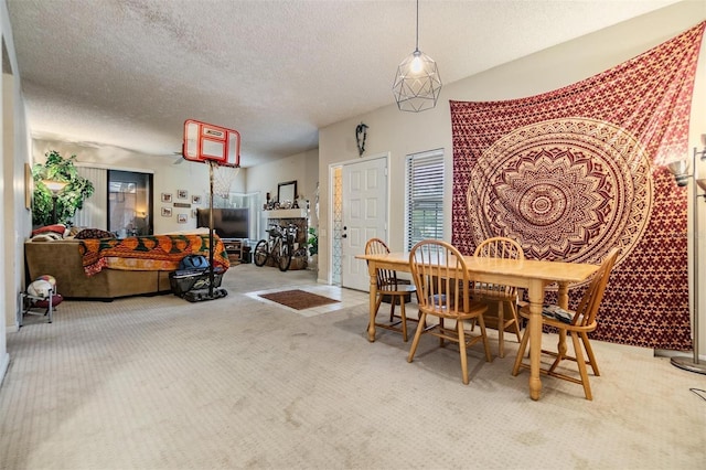 dining space featuring carpet floors and a textured ceiling