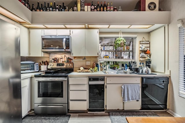 kitchen featuring light countertops, appliances with stainless steel finishes, white cabinetry, and a toaster