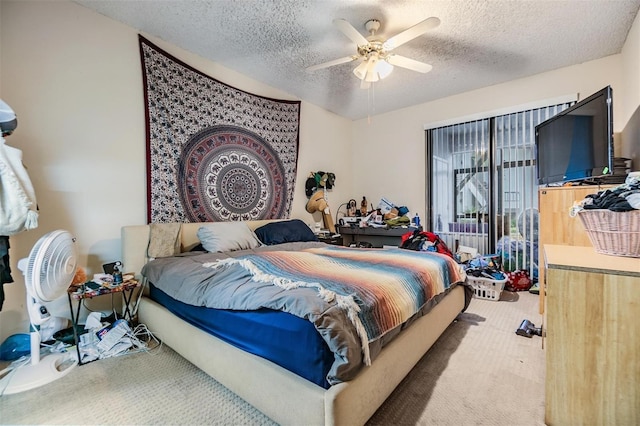 bedroom featuring a textured ceiling, a ceiling fan, and carpet flooring