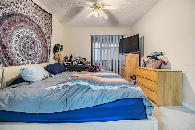 bedroom with a textured ceiling, ceiling fan, and carpet