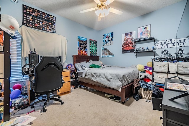 carpeted bedroom featuring a textured ceiling and a ceiling fan