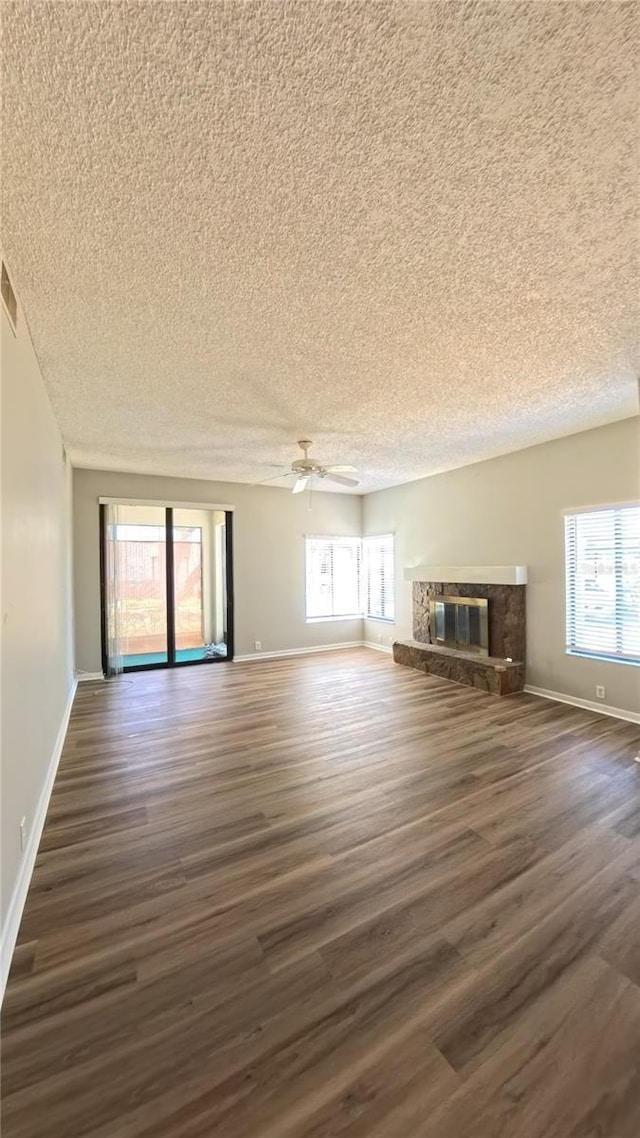1822 Lake Cypress Dr Unit 1822, Safety Harbor, FL 34695 - unfurnished living room featuring dark wood-style floors and a textured ceiling