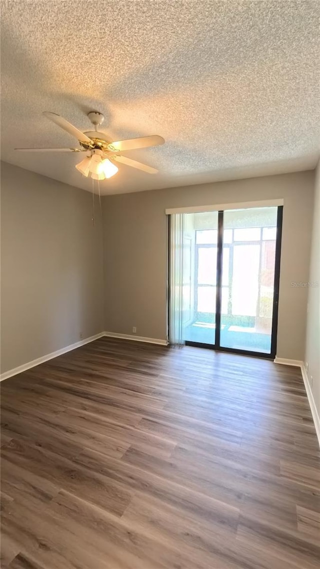 1822 Lake Cypress Dr Unit 1822, Safety Harbor, FL 34695 - empty room featuring dark wood-style flooring, a textured ceiling, baseboards, and ceiling fan