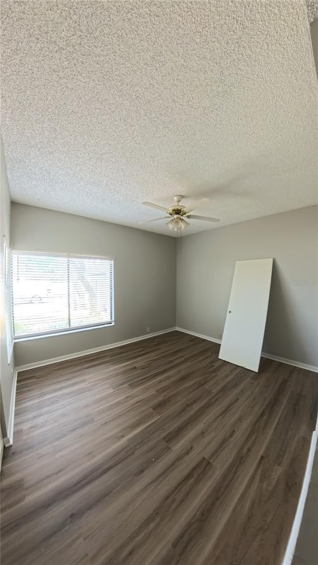 1822 Lake Cypress Dr Unit 1822, Safety Harbor, FL 34695 - spare room with a textured ceiling, dark wood-style floors, and a ceiling fan