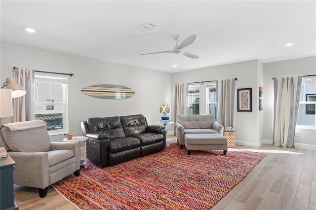 living room featuring recessed lighting, visible vents, light wood-style flooring, and baseboards