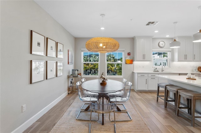 dining area with light wood-style floors, baseboards, visible vents, and recessed lighting