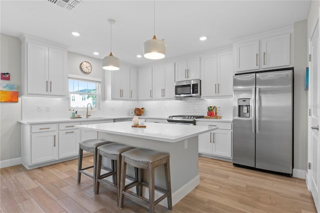 kitchen featuring white cabinetry, visible vents, appliances with stainless steel finishes, and a sink