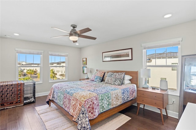 bedroom featuring recessed lighting, multiple windows, baseboards, and wood finished floors