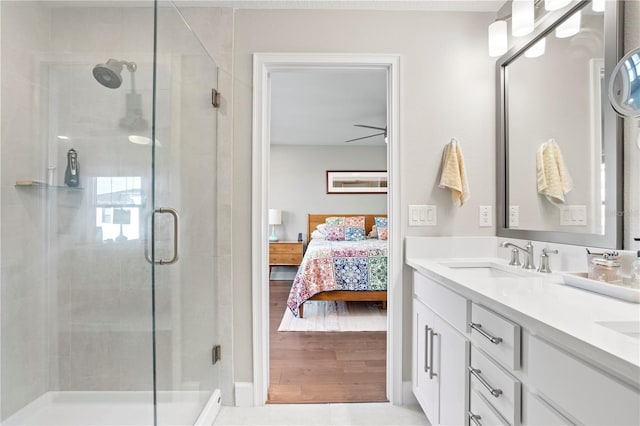 bathroom with connected bathroom, a sink, and a shower stall