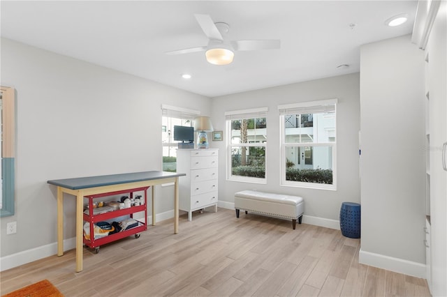 interior space with light wood-style flooring, baseboards, and ceiling fan