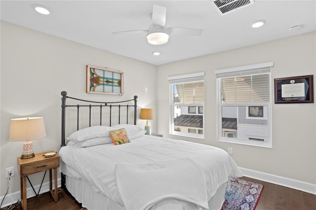 bedroom featuring dark wood-style floors, recessed lighting, visible vents, and baseboards