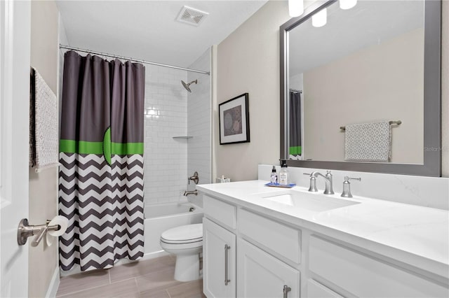 bathroom featuring visible vents, vanity, toilet, and shower / bath combo with shower curtain