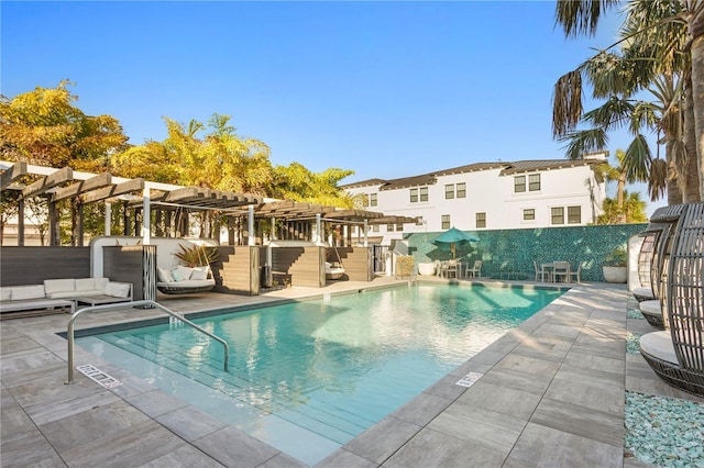 pool featuring a patio area, a residential view, and a pergola