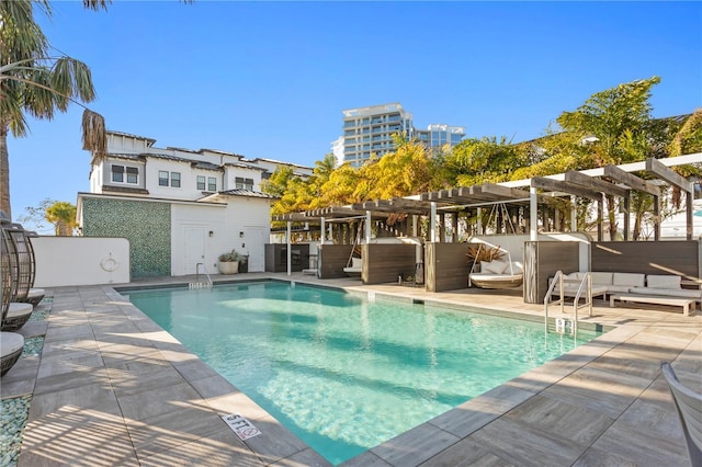 community pool with a patio area and a pergola