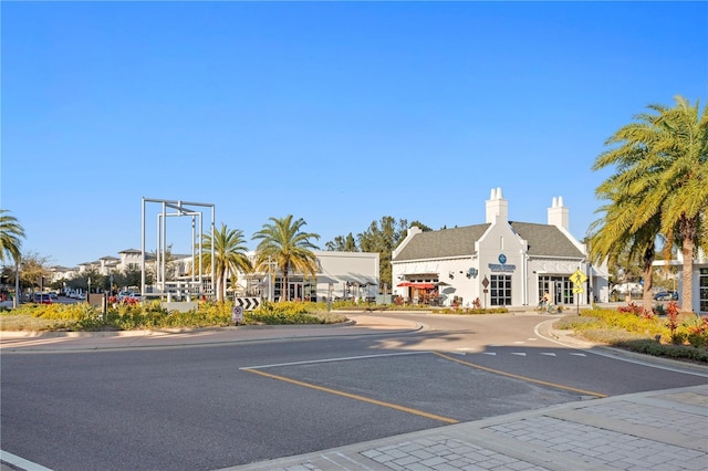 view of road with sidewalks, traffic signs, and curbs