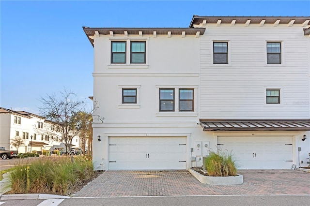 townhome / multi-family property with a standing seam roof and stucco siding