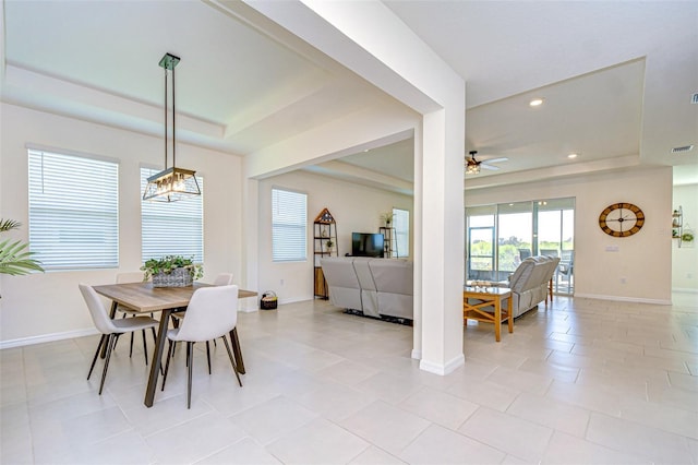 dining room featuring a ceiling fan, recessed lighting, a raised ceiling, and baseboards