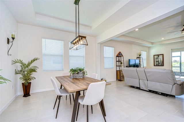 dining space featuring ceiling fan, light tile patterned floors, recessed lighting, baseboards, and a raised ceiling