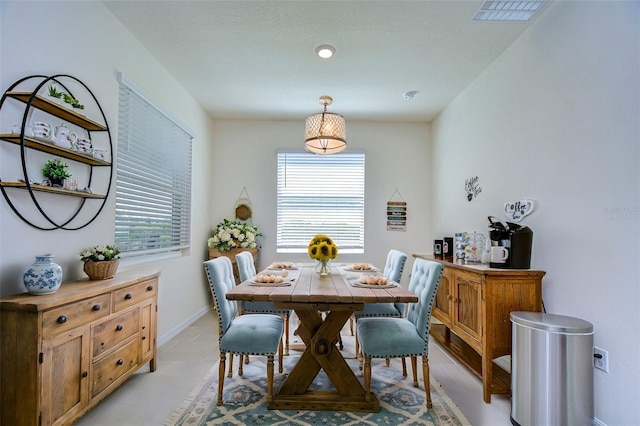 dining space featuring visible vents and baseboards