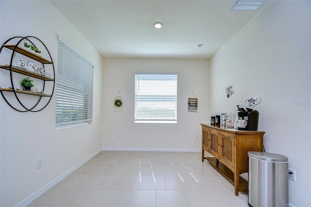 interior space with light tile patterned floors, visible vents, and baseboards