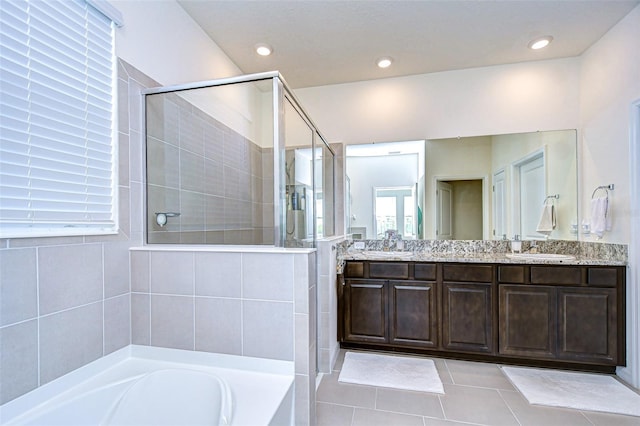 full bathroom with tile patterned flooring, recessed lighting, a sink, tiled shower, and double vanity