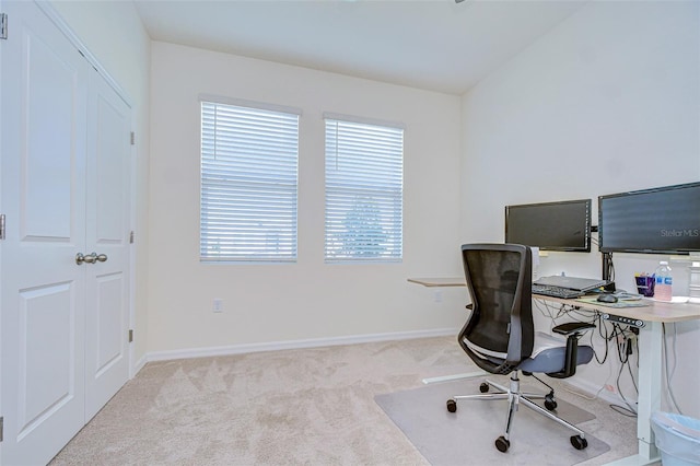 office space with light carpet and baseboards