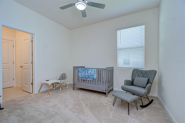 bedroom with light carpet, ceiling fan, and baseboards