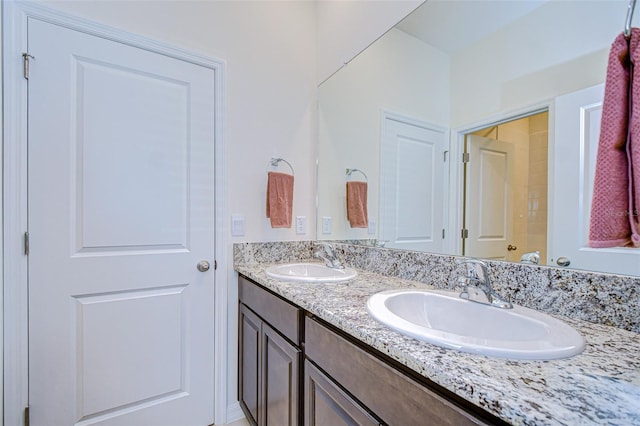 bathroom featuring a sink and double vanity