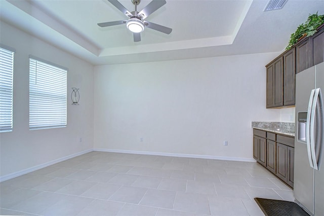 interior space featuring dark brown cabinets, a raised ceiling, visible vents, and stainless steel fridge with ice dispenser