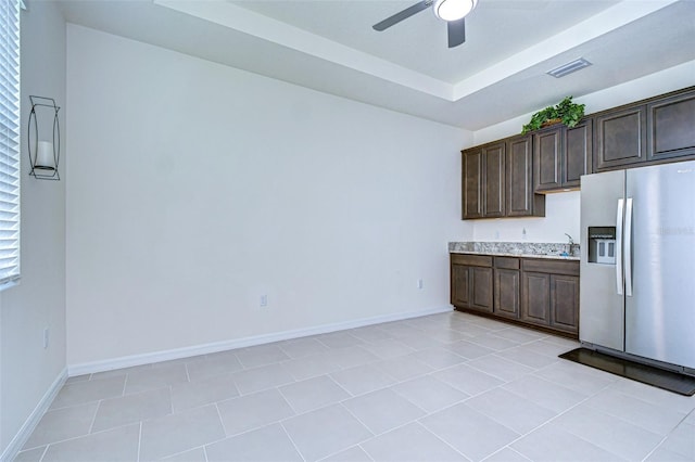 kitchen featuring dark brown cabinetry, visible vents, light countertops, and stainless steel fridge with ice dispenser