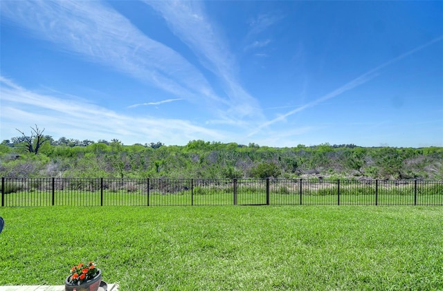 view of yard featuring a rural view and fence