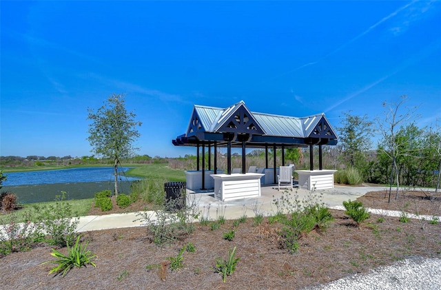 exterior space featuring a water view, a patio area, and a gazebo