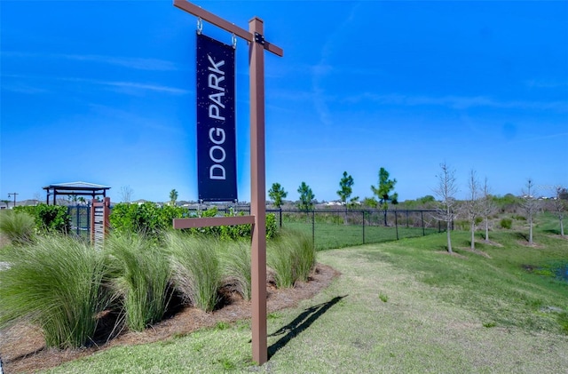 exterior space featuring a yard, playground community, and fence