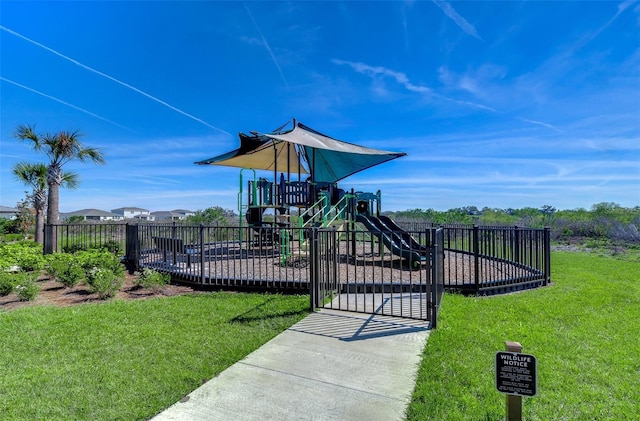 community play area with fence and a yard