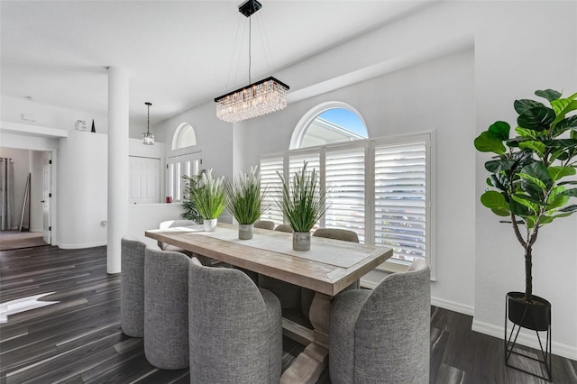14247 Spanish Wells Dr, Hudson, FL 34667 - dining room featuring dark wood-type flooring, plenty of natural light, an inviting chandelier, and baseboards