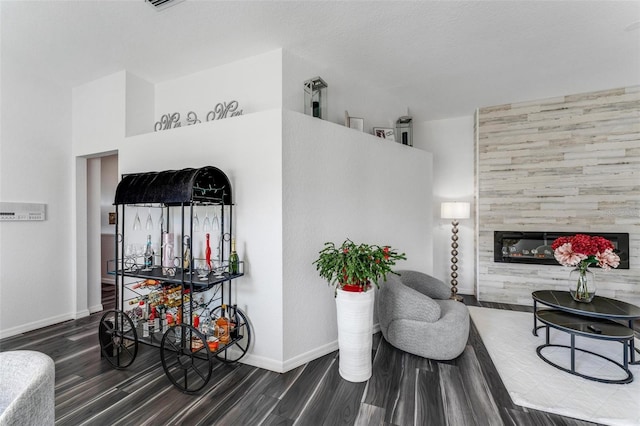 14247 Spanish Wells Dr, Hudson, FL 34667 - living area featuring baseboards, a tiled fireplace, and wood finished floors