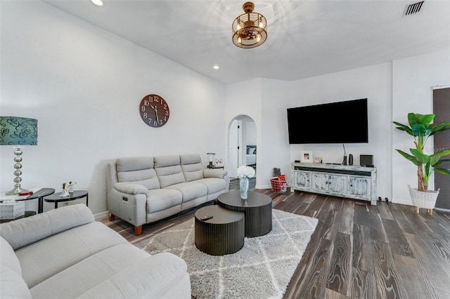 14247 Spanish Wells Dr, Hudson, FL 34667 - living area with dark wood-type flooring, arched walkways, visible vents, and recessed lighting