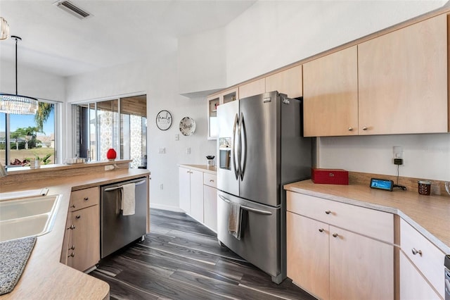 14247 Spanish Wells Dr, Hudson, FL 34667 - kitchen featuring visible vents, light countertops, appliances with stainless steel finishes, light brown cabinetry, and decorative light fixtures