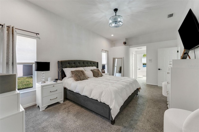 14247 Spanish Wells Dr, Hudson, FL 34667 - bedroom with visible vents, an inviting chandelier, ensuite bathroom, carpet flooring, and baseboards
