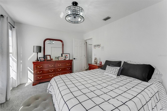 14247 Spanish Wells Dr, Hudson, FL 34667 - bedroom with an inviting chandelier, visible vents, and light colored carpet