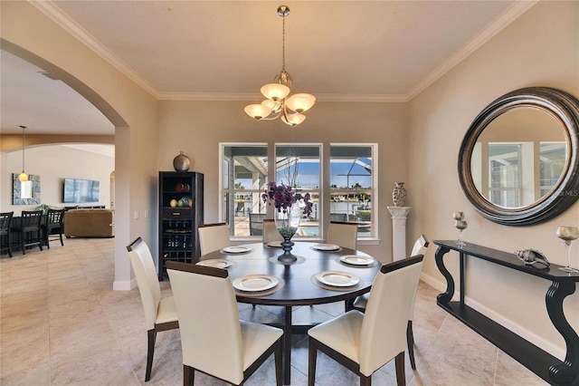 dining space featuring baseboards, arched walkways, a chandelier, and ornamental molding