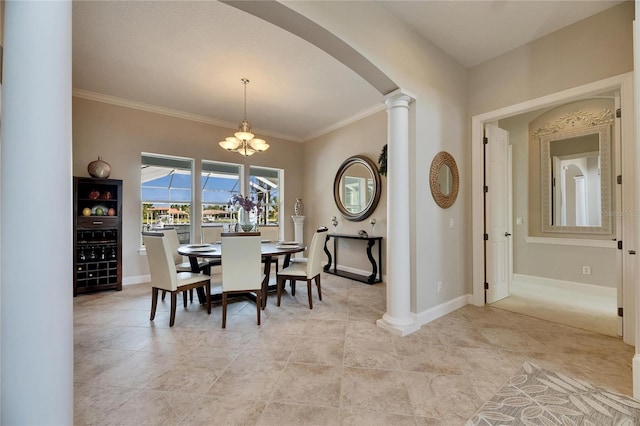 dining space with a chandelier, arched walkways, baseboards, ornate columns, and crown molding