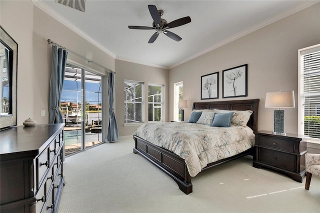 bedroom featuring visible vents, light colored carpet, ornamental molding, access to outside, and multiple windows