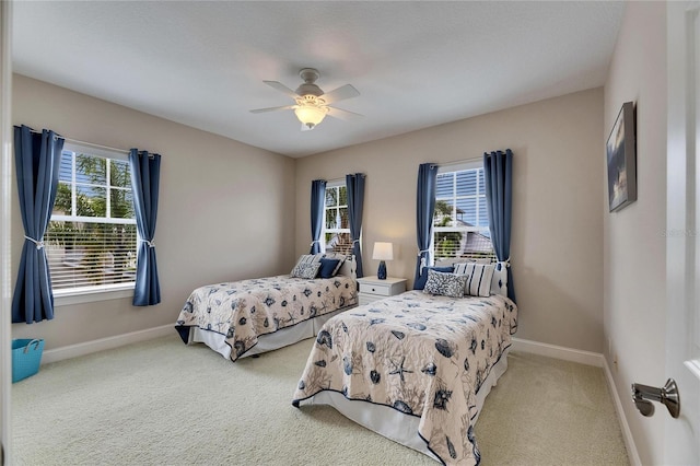 bedroom featuring baseboards, ceiling fan, and light colored carpet