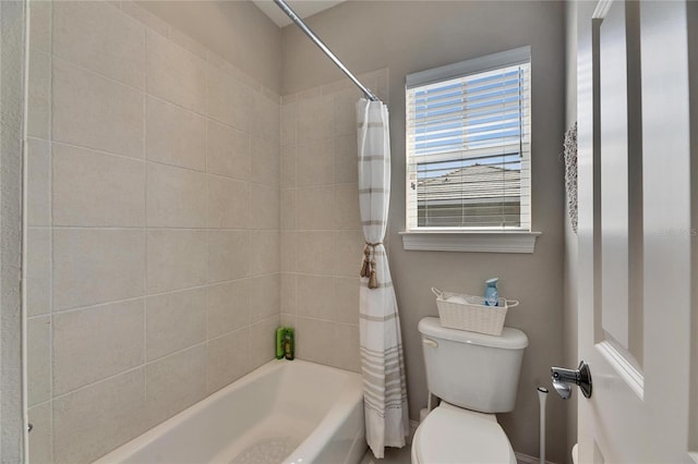 bathroom featuring shower / bath combination with curtain and toilet