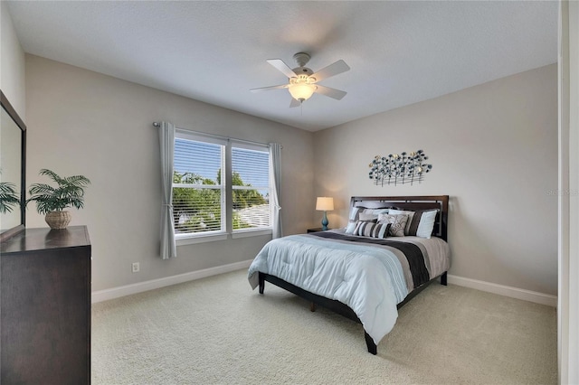 bedroom with baseboards, ceiling fan, and light colored carpet